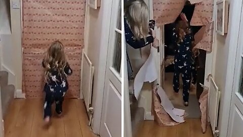 Kids run through Christmas wrapping door