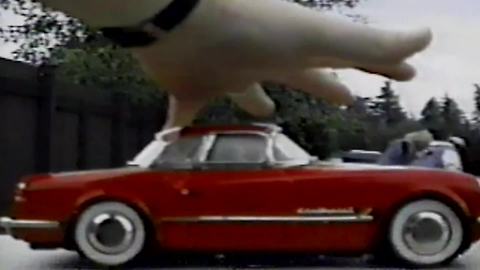 "A Giant Hand Grabbing A Car"
