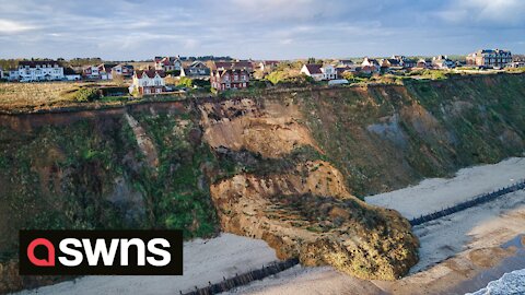 Seaside homes left dangling on cliff edge after huge landslide in Norfolk, UK