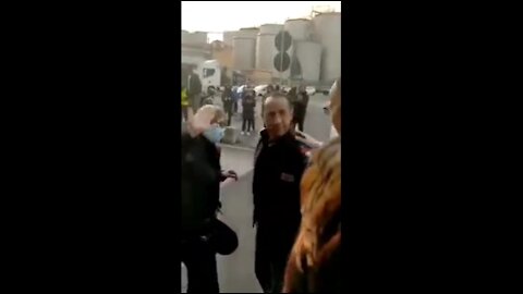 Genova Port, Italy - Policeman brings food to striking port workers