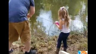 Little girl hooks giant bass during fishing trip