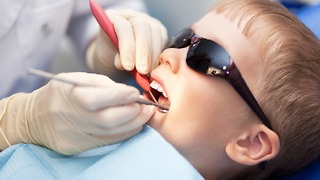 Boy gets his second needle at the dentist.