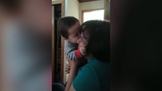 A Baby Boy Tries To Suck On A Woman's Face