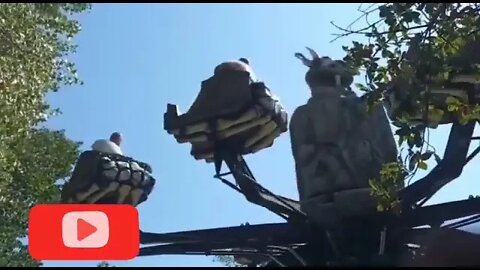 My mum on a Dinosaur ride at the amusement park