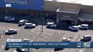 Woman shot at Walmart; two detained