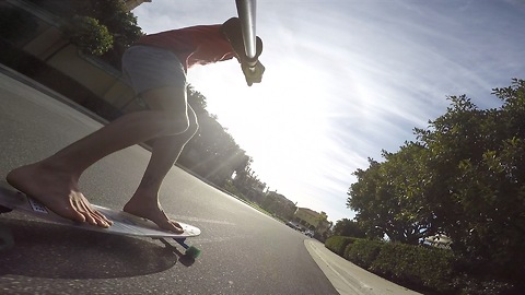 Bombing Hills on a Clear Longboard Skateboard Barefoot