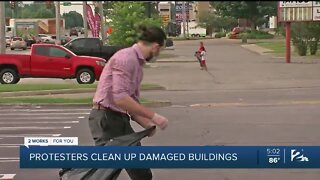 PROTESTORS CLEAN UP DAMAGED BUILDINGS