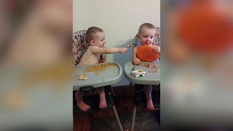 "Adorable Twin Boys Feeding Each Other"