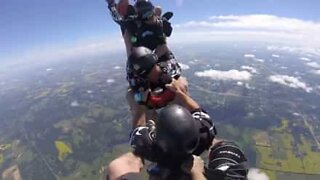 Group of friends jump out of airplane in bobsled formation