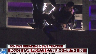 Police save woman dangling off Highway 163