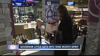 Governor Brad Little signs bottles of wine for Idaho Wine Month