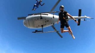 Trois casse-cous sautent en parachute depuis un hélicoptère