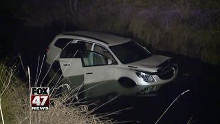 Woman hospitalized after SUV crashes into creek