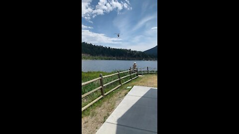 Air crane fills tanks while hovering over lake