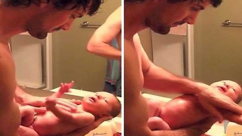 Father gives sensitive bath to his newborn daughter