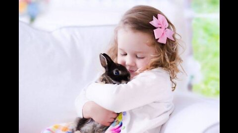 Child playing with rabbit (2021)