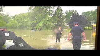 Clinton Township police rescue 82-year-old trapped in vehicle in rising flood waters
