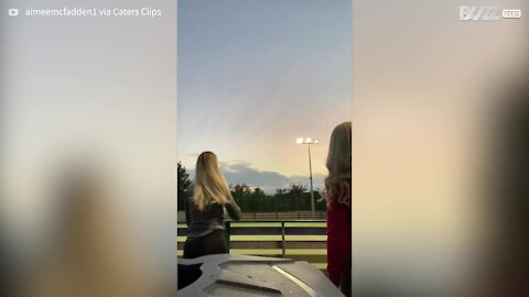 Young woman hit by soccer ball while taking photo