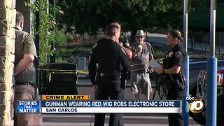 Gunman wearing red wig robs electronic store