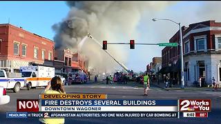 Buildings smoldering hours after a massive fire erupted in Wagoner