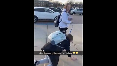 Student Walks Another Student Like A Dog Outside School