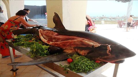 We are carving a giant shark into steaks