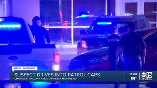 Suspect drives into patrol cars