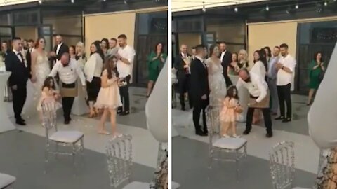 Shy flower girl gets extra help throwing rose petals