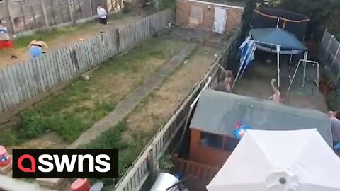 Neighbouring families beat the heatwave by having an epic water fight across their gardens