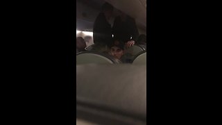 Fellow passenger helps woman during flight