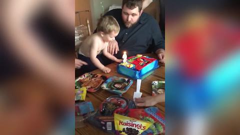 A Tot Boy Tries To Blow Out His Birthday Candle But Uses His Head Instead