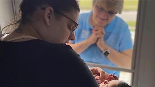 Williamsville grandma meets first grandchild through glass door