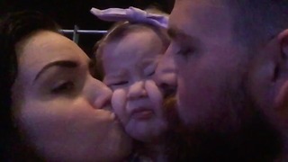 Baby girl demands hugs and kisses from parents