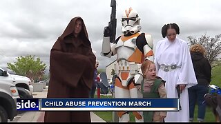 Superheroes march to prevent child abuse