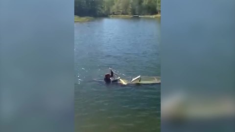 Man Rows A Sinking Canoe