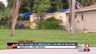 Man approaches kids playing in backyard