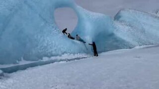 Tourist climb unusual ice formation in Alaska