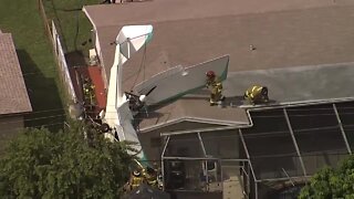 Small plane crashes onto roof of home