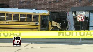 School bus driver runs light, crashes into building