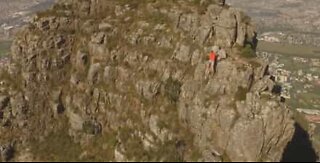 Drone footage of athlete running across Table Mountain ridge