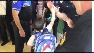 West Palm Beach police officers escort fallen officer's son to kindergarten