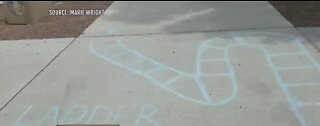 P.E. teachers draw chalk games for kids