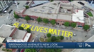 Artists paint "Black Lives Matter" on street in Greenwood District