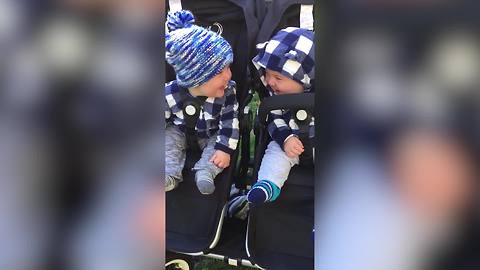 "Adorable Twin Boys Giggling in Stroller"