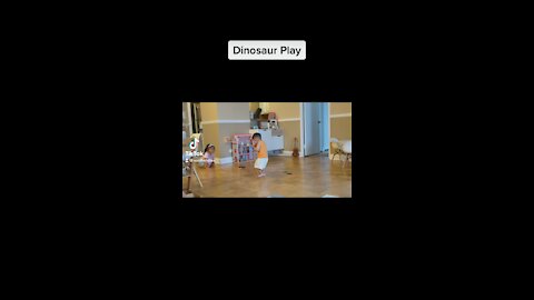 Baby boy and sister play dinosaur