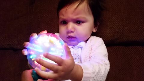 "Little Girl Dazzled By Spinning Ball Of Light"
