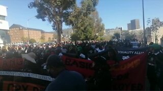 Protesters gather outside Parliament ahead of the 2022 Budget speech