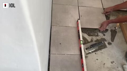Stock: Man Tiling floor