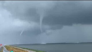 Driver captures footage of three simultaneous waterspouts