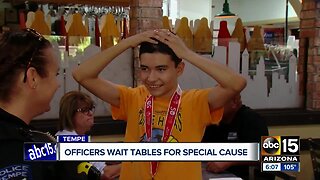 Tempe police officers wait tables Saturday for special cause